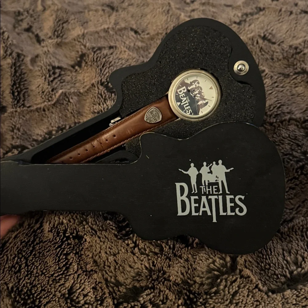 The Beatles Apple Corps Ltd. watch in its original wooden guitar-shaped case.